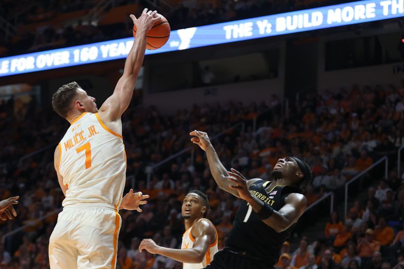 Feb 15, 2025; Knoxville, Tennessee, USA; Tennessee Volunteers forward Igor Milicic Jr. (7) blocks a shot from Vanderbilt Commodores guard Jason Edwards (1) during the first half at Thompson-Boling Arena at Food City Center. Mandatory Credit: Randy Sartin-Imagn Images