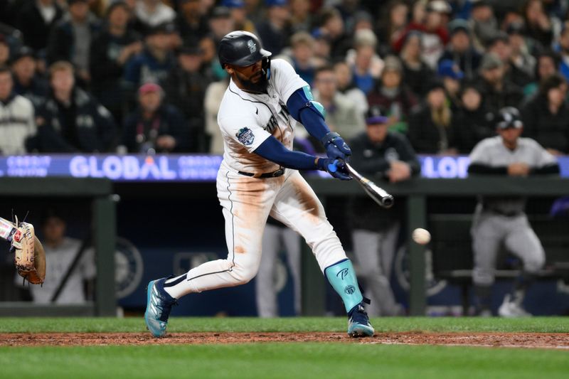 Apr 15, 2023; Seattle, Washington, USA; Seattle Mariners right fielder Teoscar Hernandez (35) hits a RBI single against the Colorado Rockies during the sixth inning at T-Mobile Park. Mandatory Credit: Steven Bisig-USA TODAY Sports