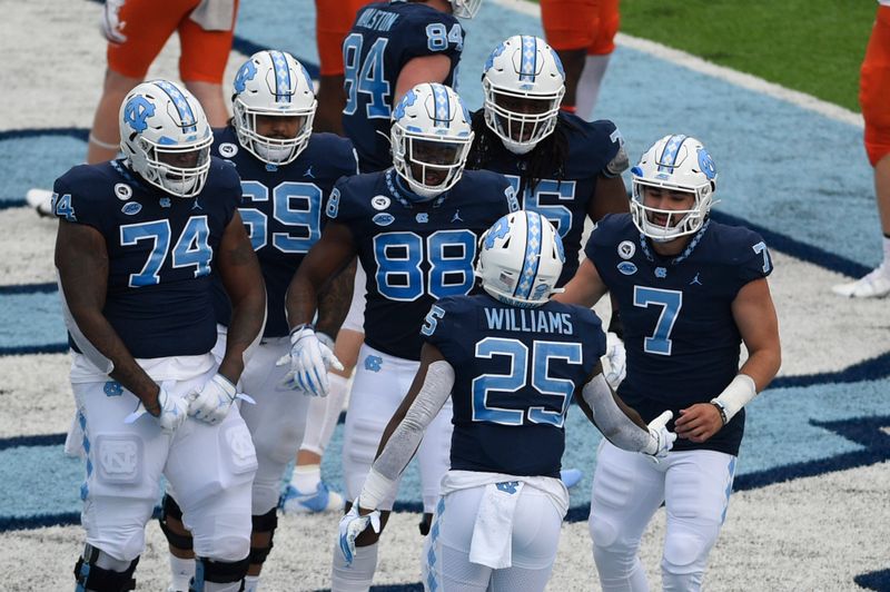 Oct 10, 2020; Chapel Hill, North Carolina, USA; North Carolina Tar Heels running back Javonte Williams (25) celebrates with teammates including quarterback Sam Howell (7) after scoring a touchdown in the first quarter at Kenan Memorial Stadium. Mandatory Credit: Bob Donnan-USA TODAY Sports