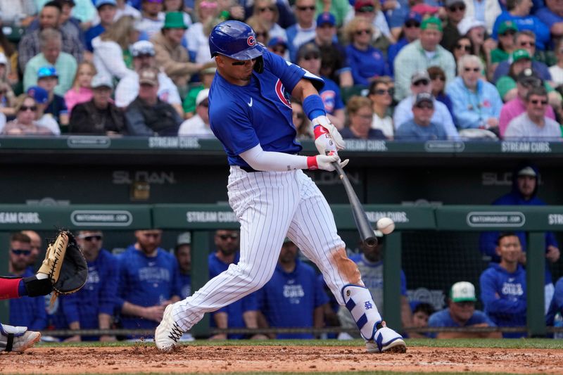 Mar 17, 2024; Mesa, Arizona, USA; Chicago Cubs right fielder Seiya Suzuki (27) hits against the Texas Rangers in the third inning at Sloan Park. Mandatory Credit: Rick Scuteri-USA TODAY Sports