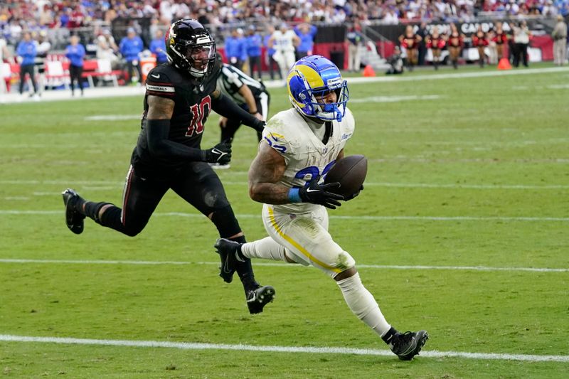 Los Angeles Rams running back Kyren Williams, right, makes a touchdown catch against Arizona Cardinals linebacker Josh Woods (10) during the second half of an NFL football game Sunday, Nov. 26, 2023, in Glendale, Ariz. The Rams won 37-14. (AP Photo/Ross D. Franklin)