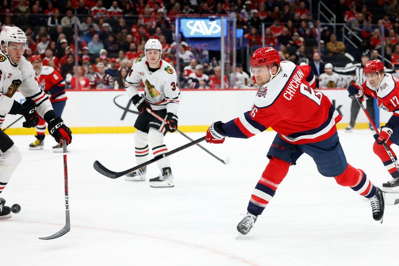 Jan 3, 2026; Washington, District of Columbia, USA; Chicago Blackhawks defenseman Matt Grzelcyk (48) blocks a shot by Washington Capitals defenseman Jakob Chychrun (6) during the first period at Capital One Arena. Mandatory Credit: Geoff Burke-Imagn Images