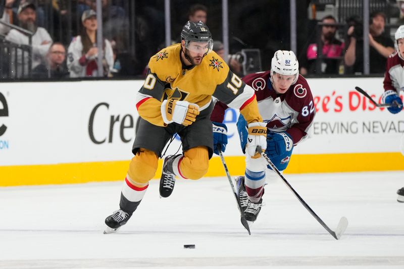 Oct 9, 2024; Las Vegas, Nevada, USA; Vegas Golden Knights center Nicolas Roy (10) skates with the puck against Colorado Avalanche center Ivan Ivan (82) during the first period at T-Mobile Arena. Mandatory Credit: Lucas Peltier-Imagn Images