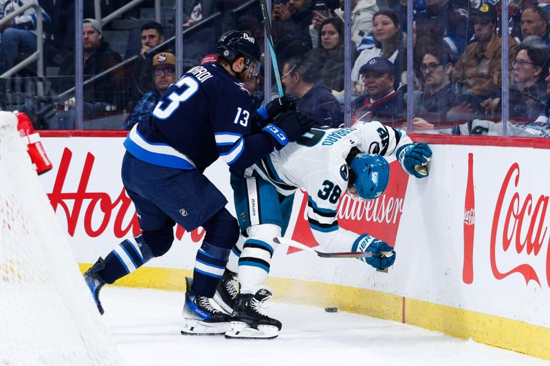 Feb 24, 2025; Winnipeg, Manitoba, CAN;  Winnipeg Jets forward Gabriel Vilardi (13) boards San Jose Sharks defenseman Mario Ferraro (38) during the second period at Canada Life Centre. Mandatory Credit: Terrence Lee-Imagn Images