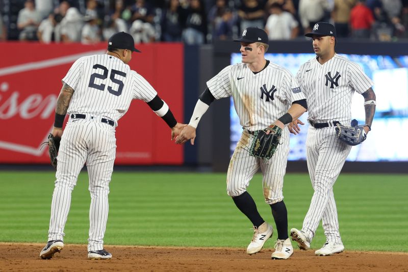 Aug 23, 2023; Bronx, New York, USA; New York Yankees center fielder Harrison Bader (22) celebrates with second baseman Gleyber Torres (25) and center fielder Everson Pereira (80) after defeating the Washington Nationals at Yankee Stadium. Mandatory Credit: Vincent Carchietta-USA TODAY Sports