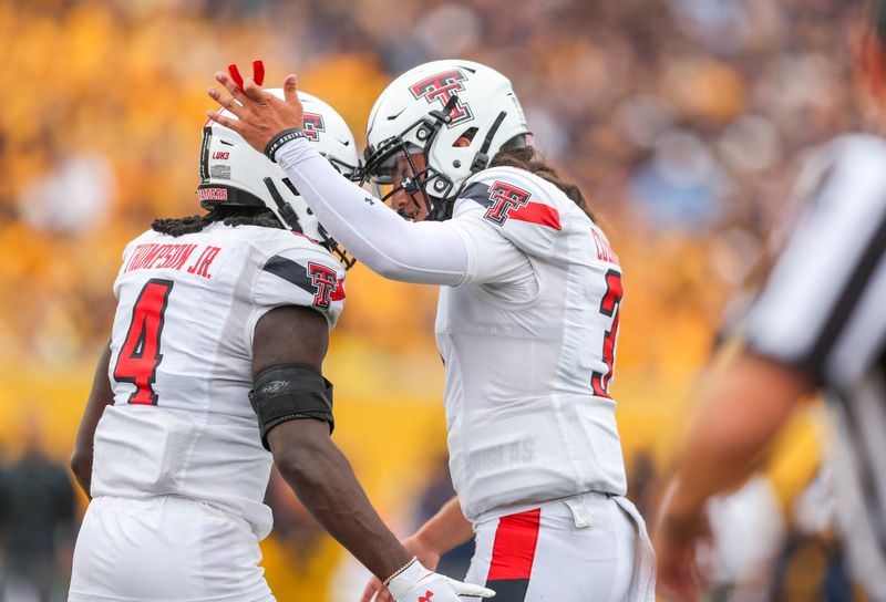 Oct 2, 2021; Morgantown, West Virginia, USA; Texas Tech Red Raiders running back SaRodorick Thompson (4) scores a touchdown and celebrates with Texas Tech Red Raiders quarterback Henry Colombi (3) during the first quarter against the West Virginia Mountaineers at Mountaineer Field at Milan Puskar Stadium. Mandatory Credit: Ben Queen-USA TODAY Sports