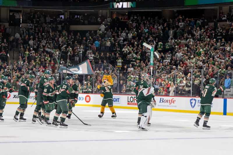 Apr 6, 2025; Saint Paul, Minnesota, USA; The Minnesota Wild salute fans after an  overtime win against the Dallas Stars at Xcel Energy Center. Mandatory Credit: Matt Blewett-Imagn Images