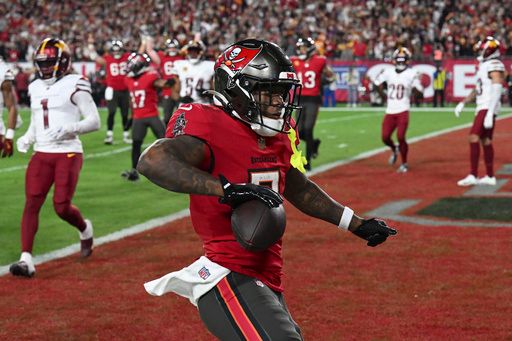 Tampa Bay Buccaneers running back Bucky Irving reacts after scoring against the Washington Commanders during the second half of an NFL wild-card playoff football game in Tampa, Fla., Sunday, Jan. 12, 2025. (AP Photo/Jason Behnken)