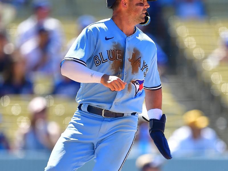 Jul 26, 2023; Los Angeles, California, USA; Toronto Blue Jays left fielder Whit Merrifield (15) scores a run against the Los Angeles Dodgers during the eighth inning at Dodger Stadium. Mandatory Credit: Gary A. Vasquez-USA TODAY Sports