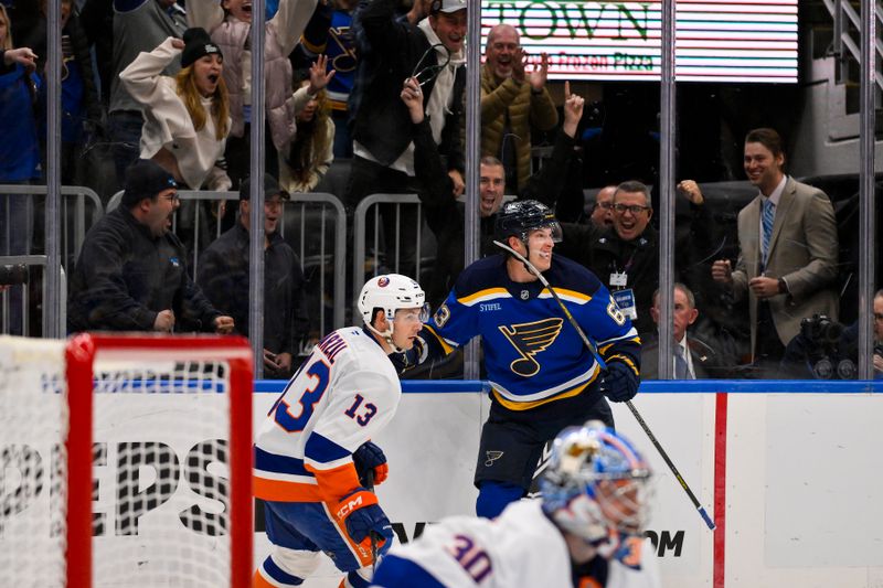 Oct 17, 2024; St. Louis, Missouri, USA;  St. Louis Blues left wing Jake Neighbours (63) reacts after scoring the game winning goal against New York Islanders goaltender Ilya Sorokin (30) in overtime at Enterprise Center. Mandatory Credit: Jeff Curry-Imagn Images