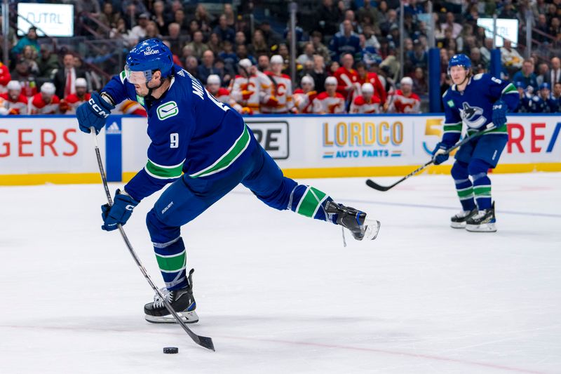 Apr 16, 2024; Vancouver, British Columbia, CAN; Vancouver Canucks forward J.T. Miller (9) scores on this shot against the Calgary Flames in the third period at Rogers Arena. Canucks won 4 -1. Mandatory Credit: Bob Frid-USA TODAY Sports