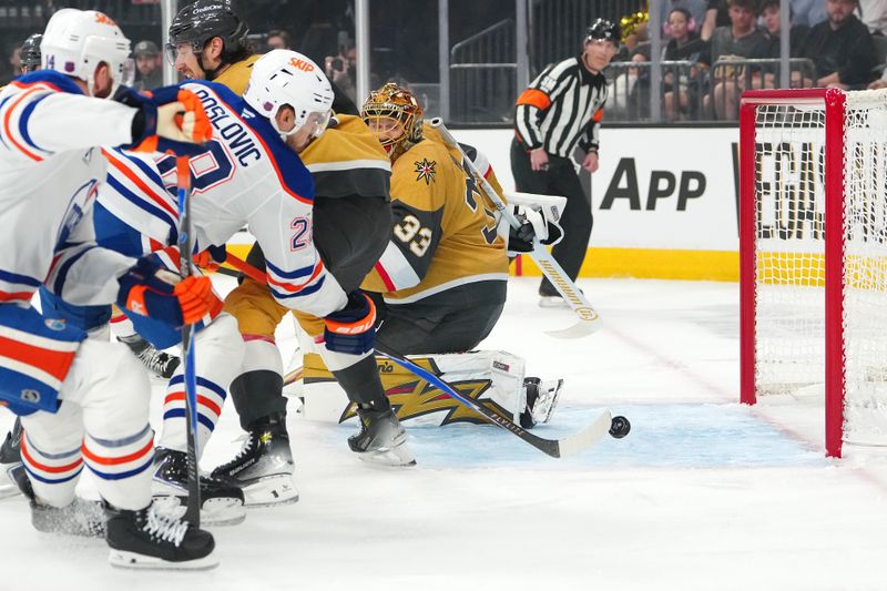 Mar 26, 2026; Las Vegas, Nevada, USA; Edmonton Oilers center Jack Roslovic (28) misses the open net behind Vegas Golden Knights goaltender Adin Hill (33) during the first period at T-Mobile Arena. Mandatory Credit: Stephen R. Sylvanie-Imagn Images Mar 26, 2026; Las Vegas, Nevada, USA; Edmonton Oilers center Jack Roslovic (28) misses the open net behind Vegas Golden Knights goaltender Adin Hill (33) during the first period at T-Mobile Arena. Mandatory Credit: Stephen R. Sylvanie-Imagn Images