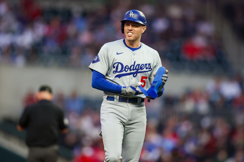 Sep 13, 2024; Atlanta, Georgia, USA; Los Angeles Dodgers first baseman Freddie Freeman (5) shows emotion between innings against the Atlanta Braves in the first inning at Truist Park. Mandatory Credit: Brett Davis-Imagn Images