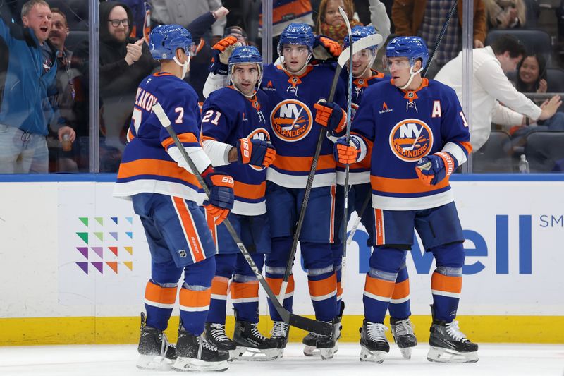 Nov 5, 2024; Elmont, New York, USA; New York Islanders center Kyle Palmieri (21) celebrates his goal against the Pittsburgh Penguins with teammates during the second period at UBS Arena. Mandatory Credit: Brad Penner-Imagn Images