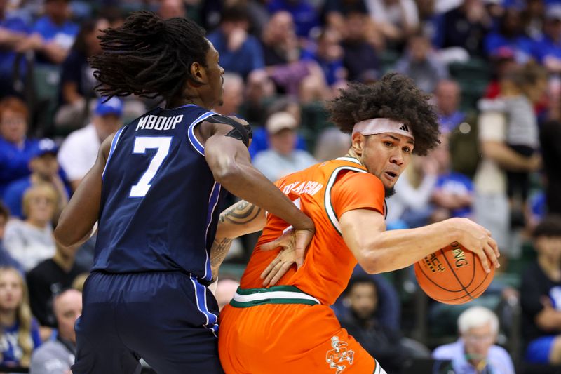 Nov 27, 2025; Kissimmee, Florida, USA; Miami (FL) Hurricanes guard Tre Donaldson (3) is guarded by Brigham Young University Cougars forward Khadim Mboup (7) in the first half at State Farm Field House. Mandatory Credit: Nathan Ray Seebeck-Imagn Images