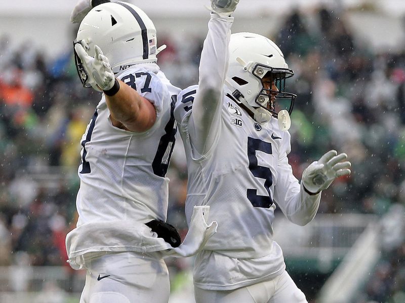 Oct 26, 2019; East Lansing, MI, USA; Penn State Nittany Lions tight end Pat Freiermuth (87) and wide receiver Jahan Dotson (5) celebrate a touchdown during the first quarter of a game against the Michigan State Spartans at Spartan Stadium. Mandatory Credit: Mike Carter-USA TODAY Sports