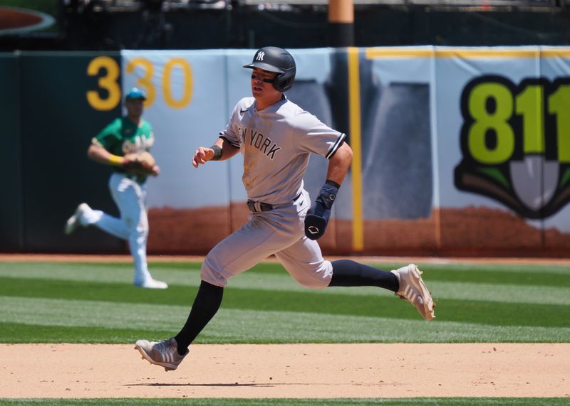 Jun 29, 2023; Oakland, California, USA; New York Yankees shortstop Anthony Volpe (11) runs to second base after an error by the Oakland Athletics trying to catch him taking a lead off first base during the sixth inning at Oakland-Alameda County Coliseum. Mandatory Credit: Kelley L Cox-USA TODAY Sports