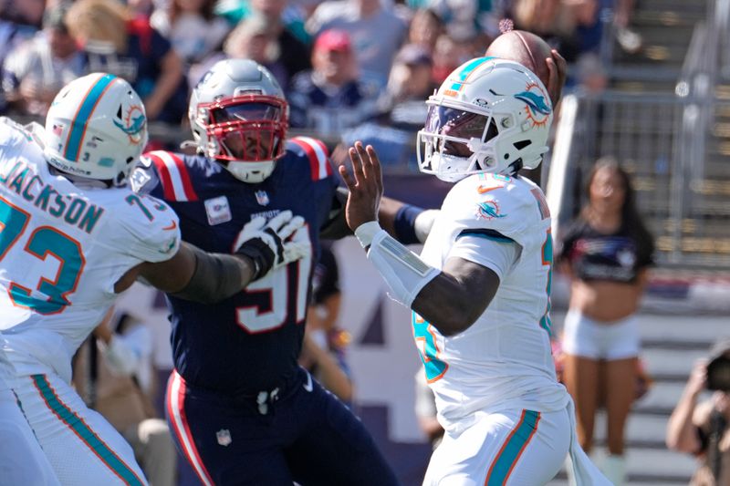 Miami Dolphins quarterback Tyler Huntley (18) throws a pass against the New England Patriots during the first half of an NFL football game, Sunday, Oct. 6, 2024, in Foxborough, Mass. (AP Photo/Michael Dwyer)