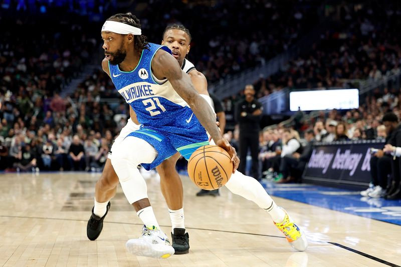 MILWAUKEE, WISCONSIN - MARCH 21: Patrick Beverley #21 of the Milwaukee Bucks drives to the basket on Dennis Smith Jr. #4 of the Brooklyn Nets during the first half of the game at Fiserv Forum on March 21, 2024 in Milwaukee, Wisconsin. NOTE TO USER: User expressly acknowledges and agrees that, by downloading and or using this photograph, User is consenting to the terms and conditions of the Getty Images License Agreement. (Photo by John Fisher/Getty Images)