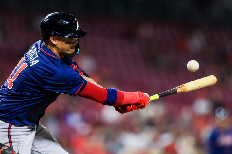 Sep 18, 2024; Cincinnati, Ohio, USA; Atlanta Braves shortstop Orlando Arcia (11) hits a double in the ninth inning against the Cincinnati Reds at Great American Ball Park. Mandatory Credit: Katie Stratman-Imagn Images