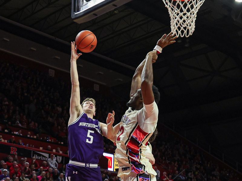 Feb 15, 2024; Piscataway, New Jersey, USA; Northwestern Wildcats guard Ryan Langborg (5) shoots the ball as Rutgers Scarlet Knights center Emmanuel Ogbole (22) defends during the first half at Jersey Mike's Arena. Mandatory Credit: Vincent Carchietta-USA TODAY Sports