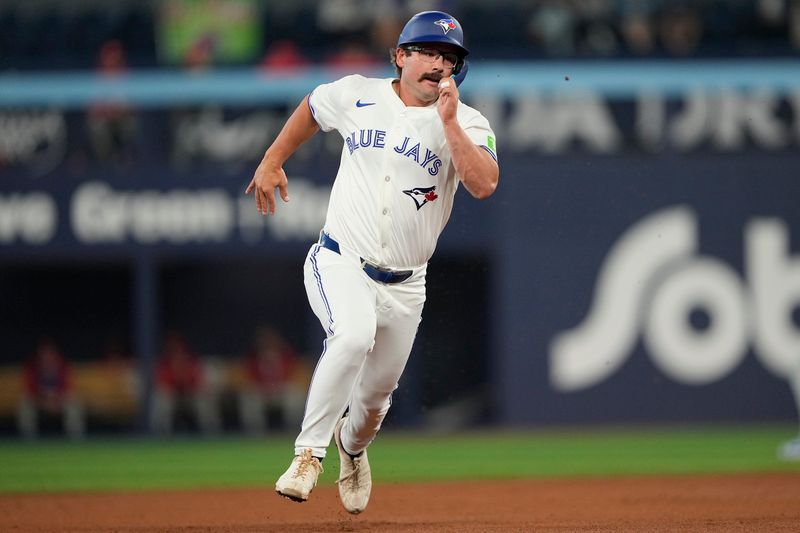 Jun 5, 2025; Toronto, Ontario, CAN; Toronto Blue Jays second baseman Davis Schneider (36) heads for home plate to score on a double hit by center fielder Myles Straw (not pictured) against the Philadelphia Phillies during the second inning at Rogers Centre. Mandatory Credit: John E. Sokolowski-Imagn Images