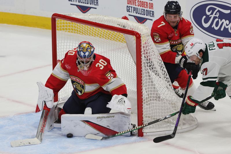 Oct 22, 2024; Sunrise, Florida, USA; Florida Panthers goaltender Spencer Knight (30) makes a save against Minnesota Wild left wing Marcus Foligno (17) during the third period at Amerant Bank Arena. Mandatory Credit: Sam Navarro-Imagn Images