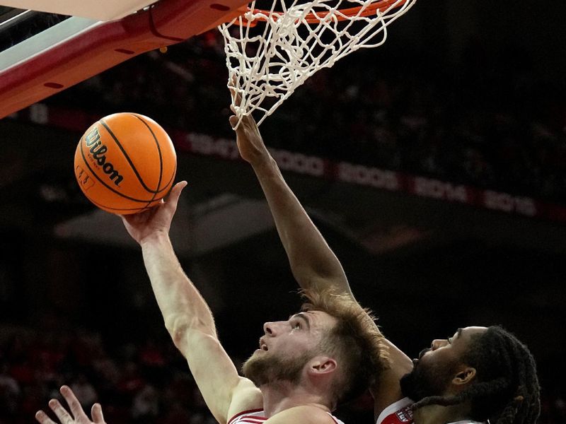 Feb 13, 2024; Madison, Wisconsin, USA;Wisconsin forward Tyler Wahl (5) scores on Ohio State guard Bruce Thornton (2) during the second half of their game at the Kohl Center. Mandatory Credit: Mark Hoffman/Milwaukee Journal Sentinelf-USA TODAY Sports
