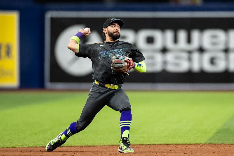 May 11, 2024; St. Petersburg, Florida, USA; Tampa Bay Rays shortstop José Caballero (7) throws the ball to first base for an out against the New York Yankees during the ninth inning at Tropicana Field. Mandatory Credit: Matt Pendleton-USA TODAY Sports