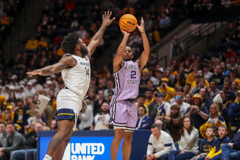 Jan 9, 2024; Morgantown, West Virginia, USA; Kansas State Wildcats guard Tylor Perry (2) shoots a three pointer over West Virginia Mountaineers guard Seth Wilson (14) during the first half at WVU Coliseum. Mandatory Credit: Ben Queen-USA TODAY Sports