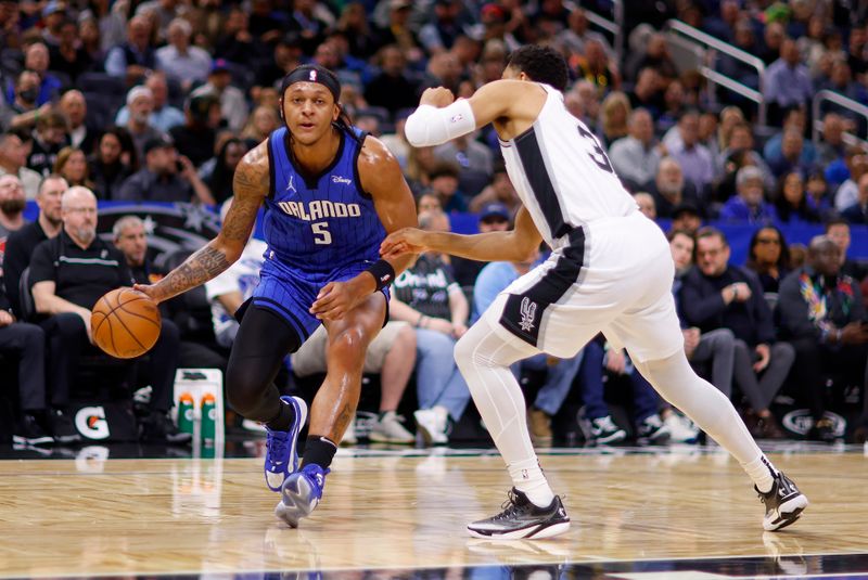 ORLANDO, FLORIDA - FEBRUARY 08: Paolo Banchero #5 of the Orlando Magic drives to the basket  during a game against the San Antonio Spurs at Kia Center on February 08, 2024 in Orlando, Florida. (Photo by Mike Ehrmann/Getty Images) NOTE TO USER: User expressly acknowledges and agrees that, by downloading and or using this photograph, User is consenting to the terms and conditions of the Getty Images License Agreement. (Photo by Mike Ehrmann/Getty Images)