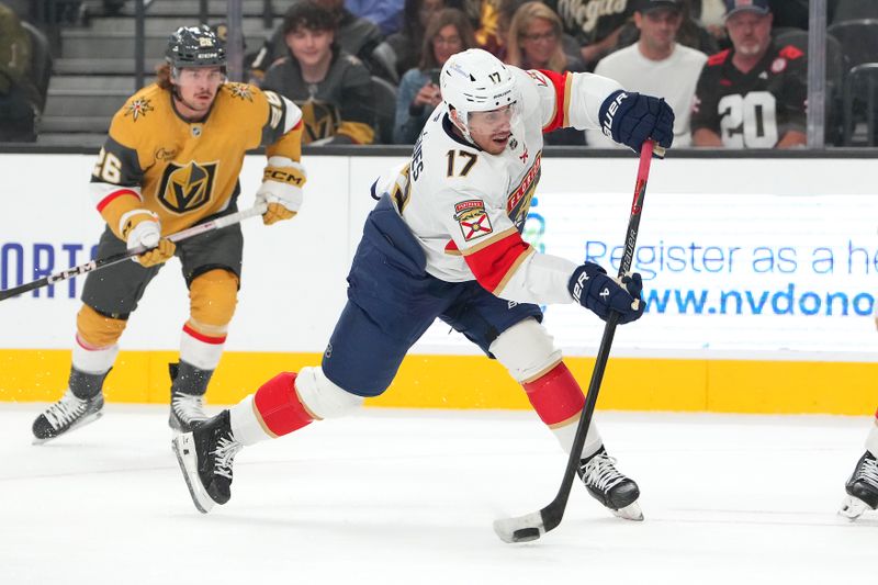 Nov 10, 2025; Las Vegas, Nevada, USA; Florida Panthers center Evan Rodrigues (17) shoots against the Vegas Golden Knights during the first period at T-Mobile Arena. Mandatory Credit: Stephen R. Sylvanie-Imagn Images