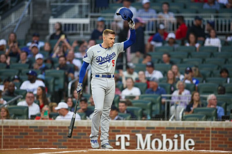 Sep 13, 2024; Atlanta, Georgia, USA; Los Angeles Dodgers first baseman Freddie Freeman (5) acknowledges the crowd before an at bat against the Atlanta Braves in the first inning at Truist Park. Mandatory Credit: Brett Davis-Imagn Images