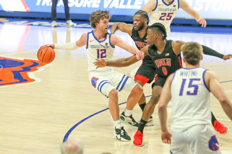 Feb 19, 2023; Boise, Idaho, USA; UNLV Rebels forward Victor Iwuakor (0) and guard EJ Harkless (55) pressure Boise State Broncos guard Max Rice (12) during the second half at ExtraMile Arena. Boise State beats UNLV 73-69.   Mandatory Credit: Brian Losness-USA TODAY Sports
