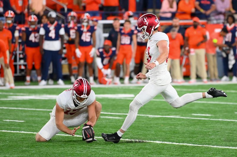 Sep 20, 2024; Syracuse, New York, USA; Stanford Cardinal place kicker Emmet Kenney (13) kicks the game winning field goal from the hold of punter Connor Weselman (15) against the Syracuse Orange during the second half at the JMA Wireless Dome. Mandatory Credit: Rich Barnes-Imagn Images