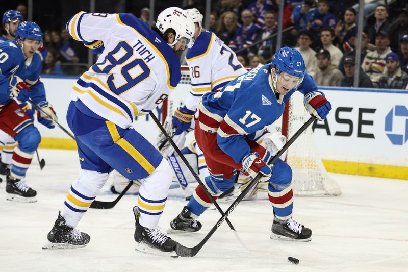 Jan 8, 2026; New York, New York, USA;  Buffalo Sabres right wing Alex Tuch (89) and New York Rangers defenseman Will Borgen (17) battle for control of the puck in the first period at Madison Square Garden. Mandatory Credit: Wendell Cruz-Imagn Images