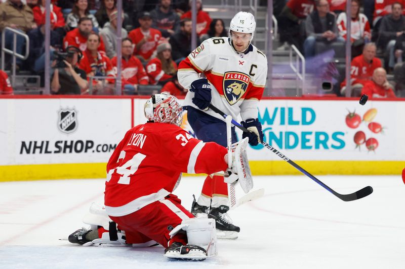 Mar 2, 2024; Detroit, Michigan, USA; Detroit Red Wings goaltender Alex Lyon (34) makes a save in front of Florida Panthers center Aleksander Barkov (16) in the third period at Little Caesars Arena. Mandatory Credit: Rick Osentoski-USA TODAY Sports