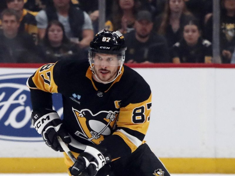 Apr 15, 2024; Pittsburgh, Pennsylvania, USA;  Pittsburgh Penguins center Sidney Crosby (87) skates up ice with the puck against the Nashville Predators during the first period at PPG Paints Arena. Mandatory Credit: Charles LeClaire-USA TODAY Sports