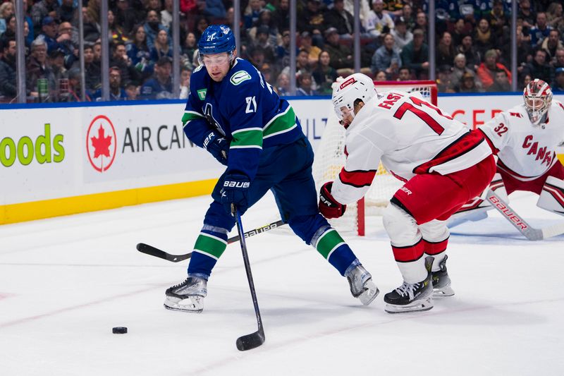 Dec 9, 2023; Vancouver, British Columbia, CAN; Carolina Hurricanes forward Jesper Fast (71) battles with Vancouver Canucks forward Nils Hoglander (21) in the first period at Rogers Arena. Mandatory Credit: Bob Frid-USA TODAY Sports