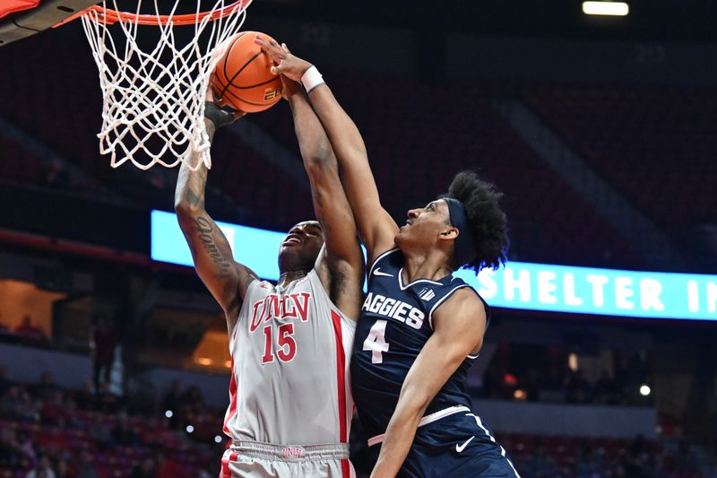 Jan 13, 2024; Las Vegas, Nevada, USA; UNLV Rebels guard Luis Rodriguez (15) tries to score on Utah State Aggies guard Ian Martinez (4) in the first half at Thomas & Mack Center. Mandatory Credit: Candice Ward-USA TODAY Sports