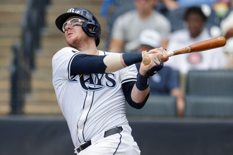 Jul 20, 2025; Tampa, Florida, USA; Tampa Bay Rays catcher Danny Jansen (19) hits a home runagainst the Baltimore Orioles in the fourth inning at George M. Steinbrenner Field. Mandatory Credit: Nathan Ray Seebeck-Imagn Images