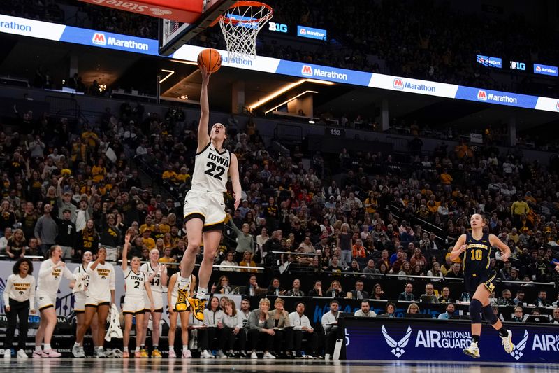 Mar 9, 2024; Minneapolis, MN, USA;  Iowa Hawkeyes guard Caitlin Clark (22) lays the ball in against the Michigan Wolverines during the second half of a Big Ten Women's Basketball tournament semifinal at Target Center. Mandatory Credit: Nick Wosika-USA TODAY Sports