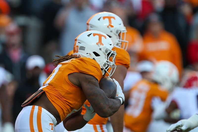 Nov 18, 2023; Knoxville, Tennessee, USA; Tennessee Volunteers running back Jaylen Wright (0) runs the first play from scrimmage for a touchdown against the Georgia Bulldogs during the first half at Neyland Stadium. Mandatory Credit: Randy Sartin-USA TODAY Sports