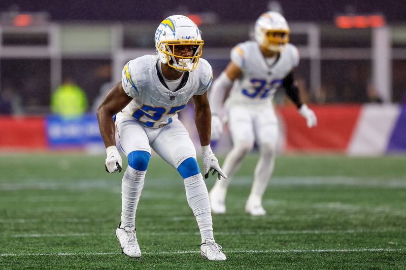 Los Angeles Chargers cornerback Essang Bassey (27) drops into coverage during the second half of an NFL football game against the New England Patriots on Sunday, Dec. 3, 2023, in Foxborough, Mass. (AP Photo/Greg M. Cooper)