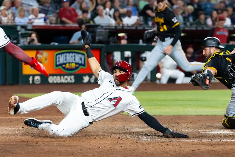 May 27, 2025; Phoenix, Arizona, USA; Arizona Diamondbacks base runner Jordan Lawlar slides into home to score against the Pittsburgh Pirates in the fourth inning at Chase Field. Mandatory Credit: Mark J. Rebilas-Imagn Images