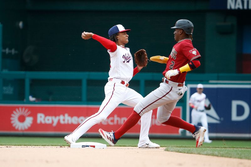 Jun 22, 2023; Washington, District of Columbia, USA; Washington Nationals shortstop CJ Abrams (5) tags out Arizona Diamondbacks shortstop Geraldo Perdomo (2) on second base and throws the ball to first during the first inning at Nationals Park. Mandatory Credit: Amber Searls-USA TODAY Sports