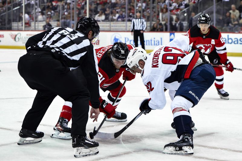 Nov 10, 2023; Newark, New Jersey, USA; New Jersey Devils center Dawson Mercer (91) faces off with Washington Capitals center Evgeny Kuznetsov (92) during the second period at Prudential Center. Mandatory Credit: John Jones-USA TODAY Sports