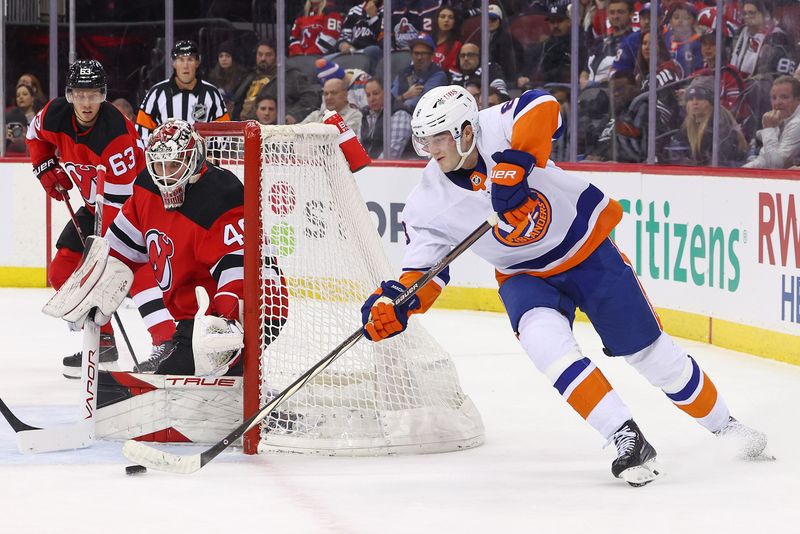 Nov 28, 2023; Newark, New Jersey, USA; New York Islanders defenseman Noah Dobson (8) shoots the puck towards the net of New Jersey Devils goaltender Akira Schmid (40) during the third period at Prudential Center. Mandatory Credit: Ed Mulholland-USA TODAY Sports