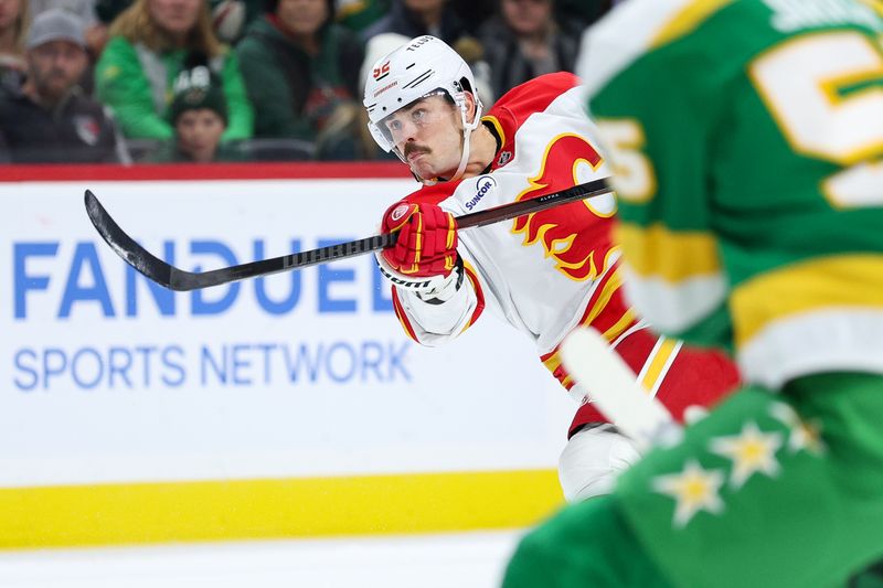 Nov 9, 2025; Saint Paul, Minnesota, USA; Calgary Flames defenseman Mackenzie Weegar (52) shoots the puck against the Minnesota Wild during the third period at Grand Casino Arena. Mandatory Credit: Matt Krohn-Imagn Images