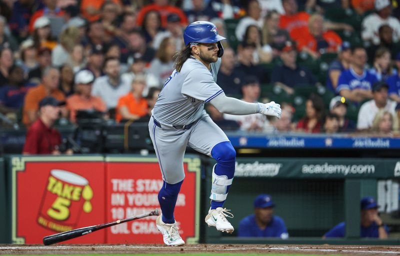 Apr 2, 2024; Houston, Texas, USA; Toronto Blue Jays shortstop Bo Bichette (11) hits a single during the first inning against the Houston Astros at Minute Maid Park. Mandatory Credit: Troy Taormina-USA TODAY Sports